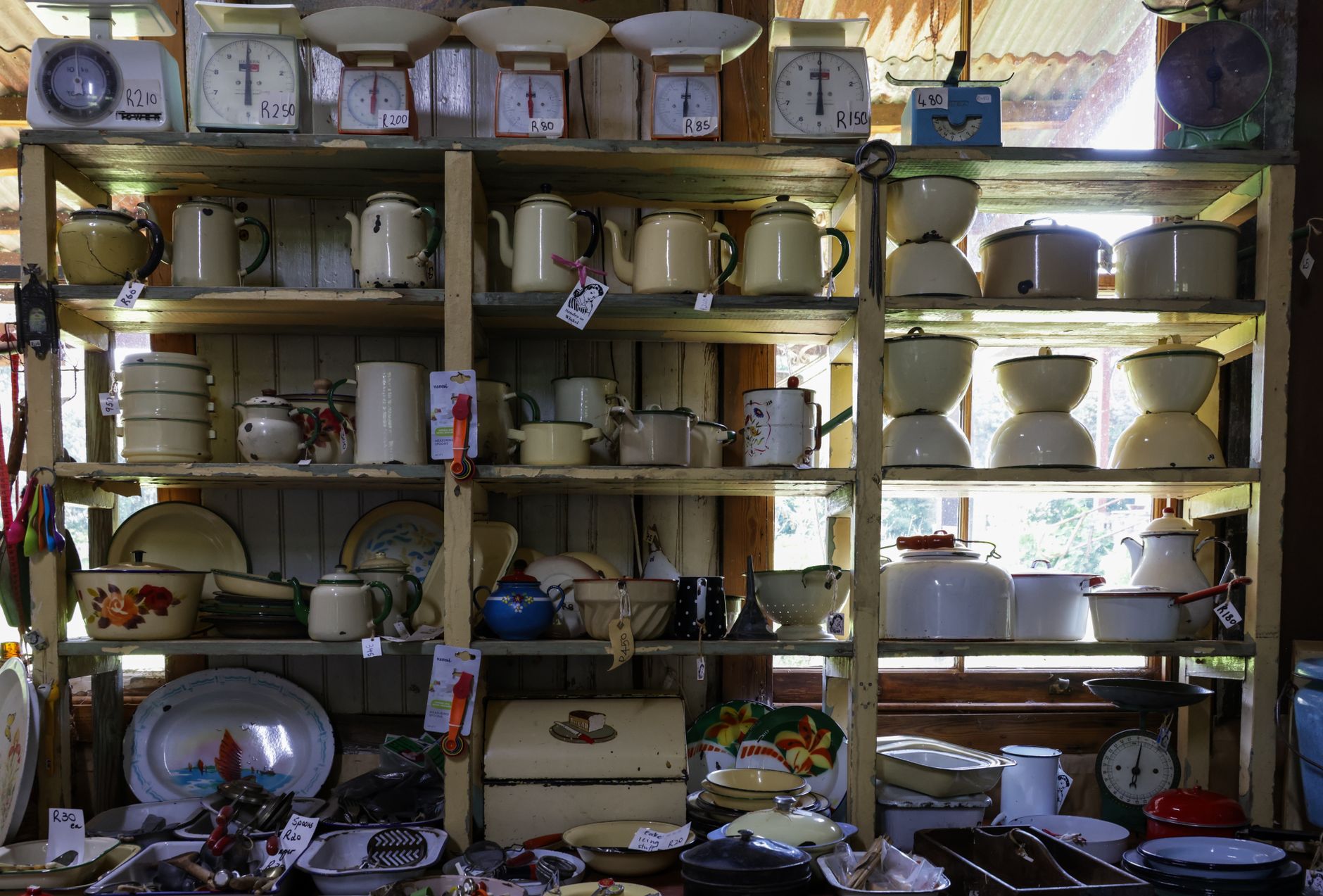 Shelves displaying vintage household objects